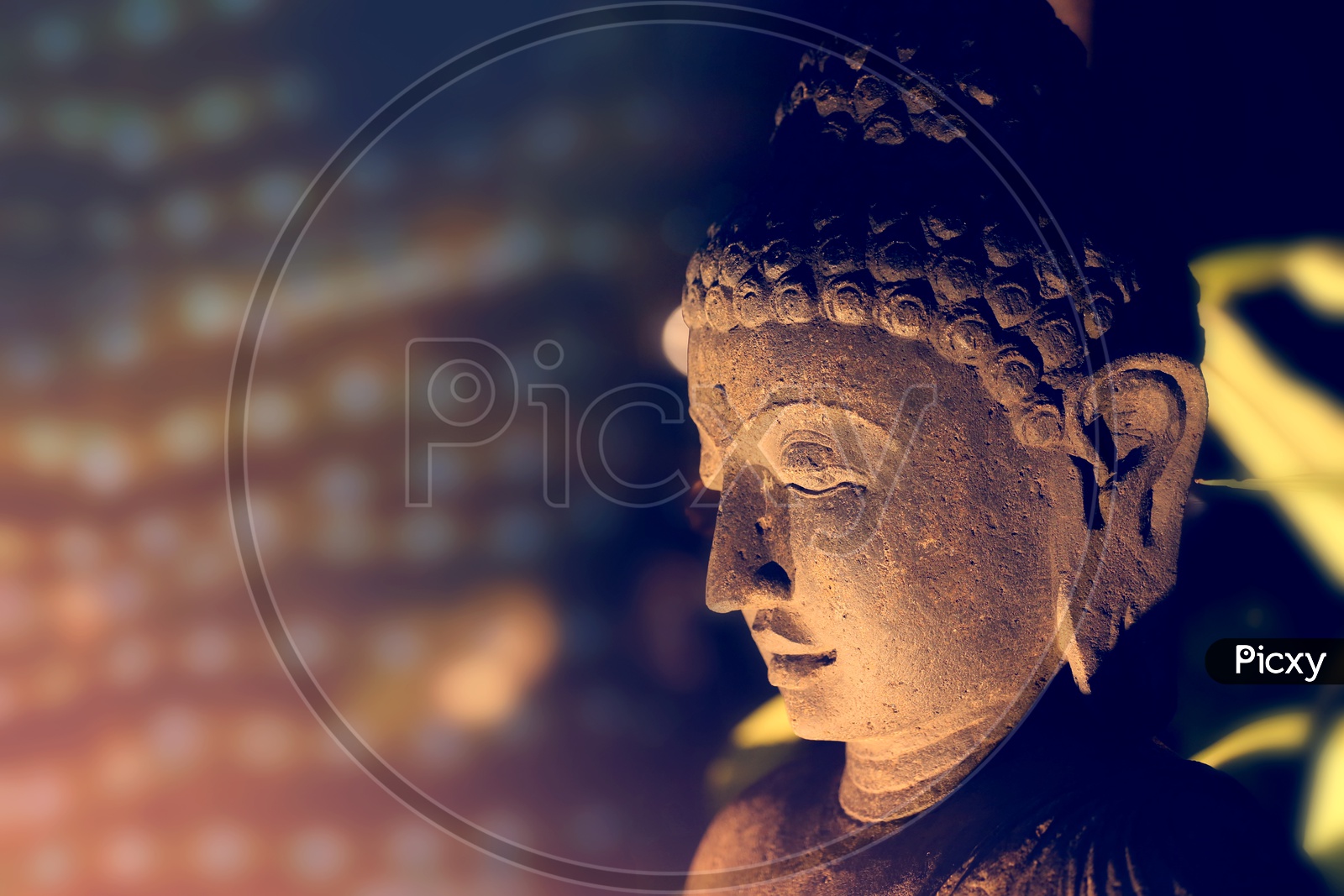 Face of the Buddha lit by a soft light