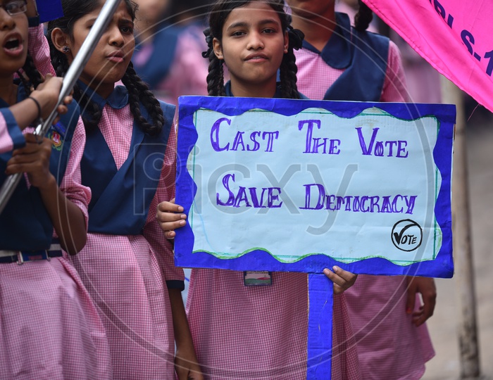 girl student holding a placard for vote awareness