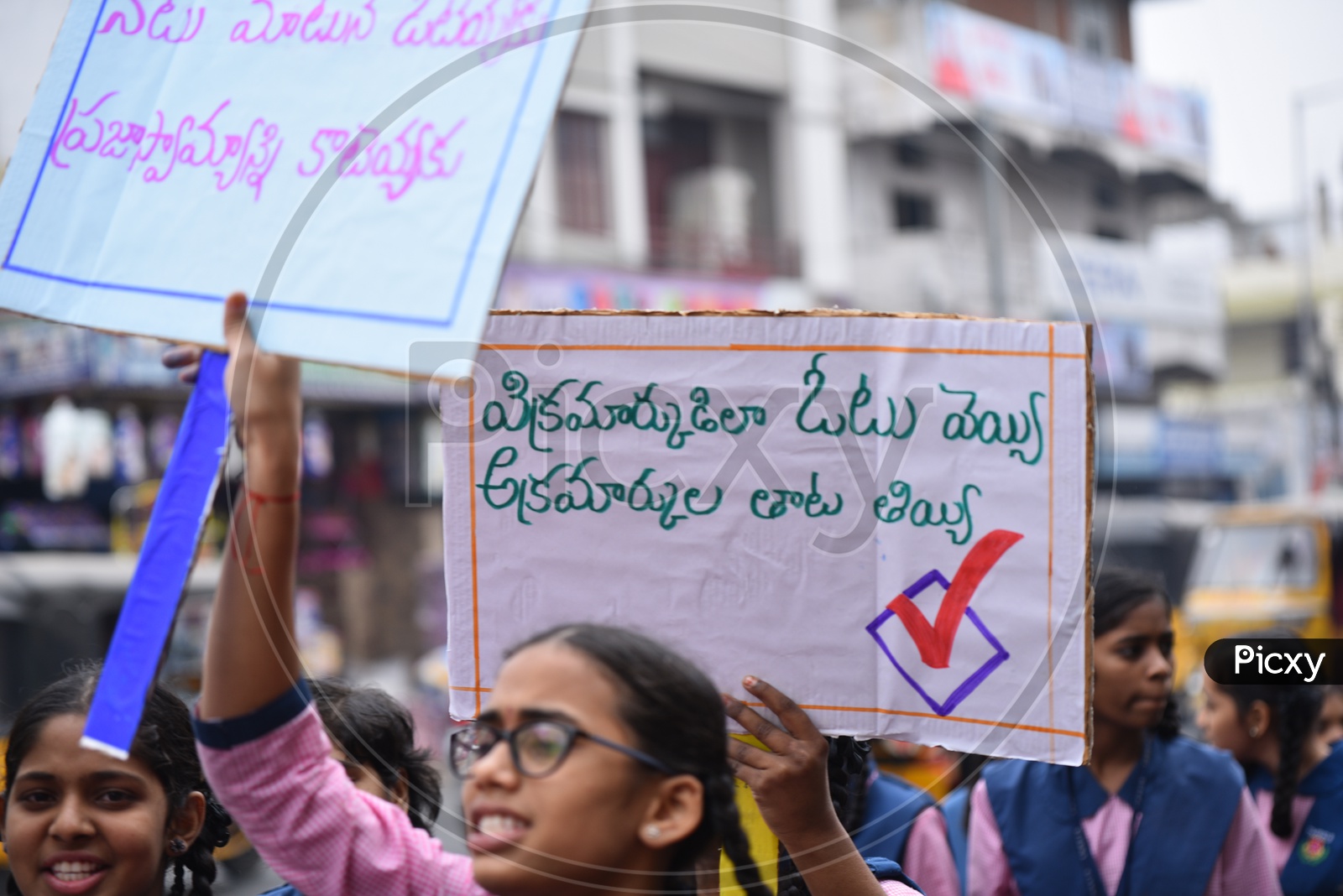 Girl students  showing placards to make use of vote