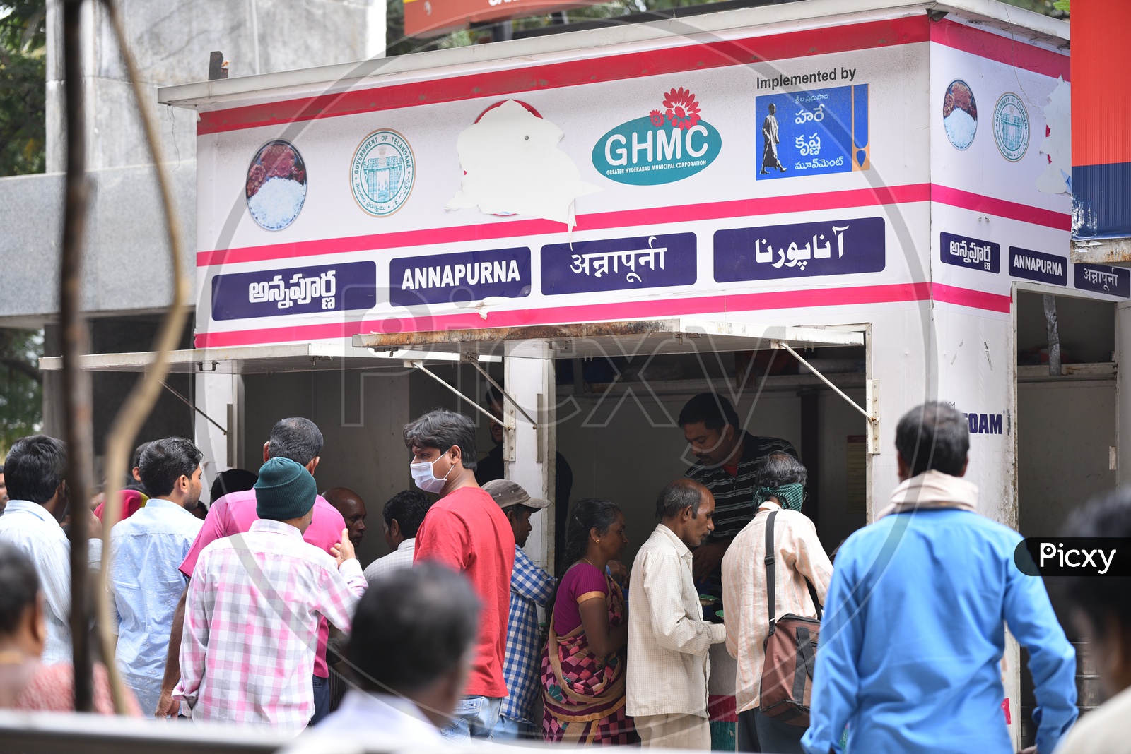 People Standing For Meals At GHMC Annapurna Meal Counter.