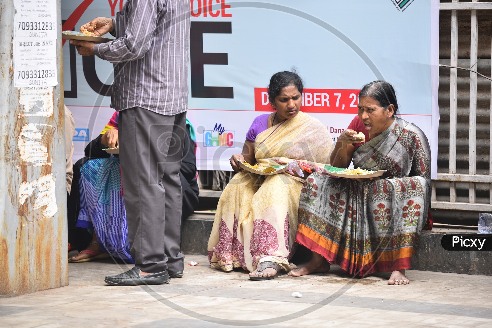 Women Having their meal brought from  GHMC Annapurna Meal Counter.