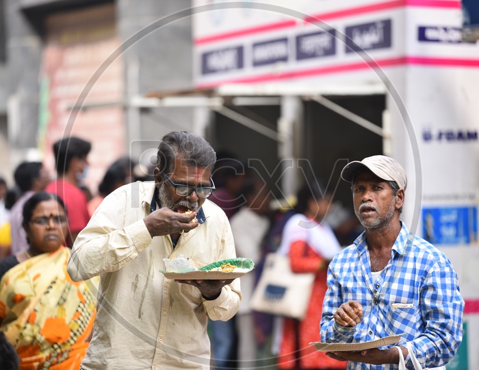 Two Oldmen Having their meals brought from GHMC Annapurna Meal Counter.
