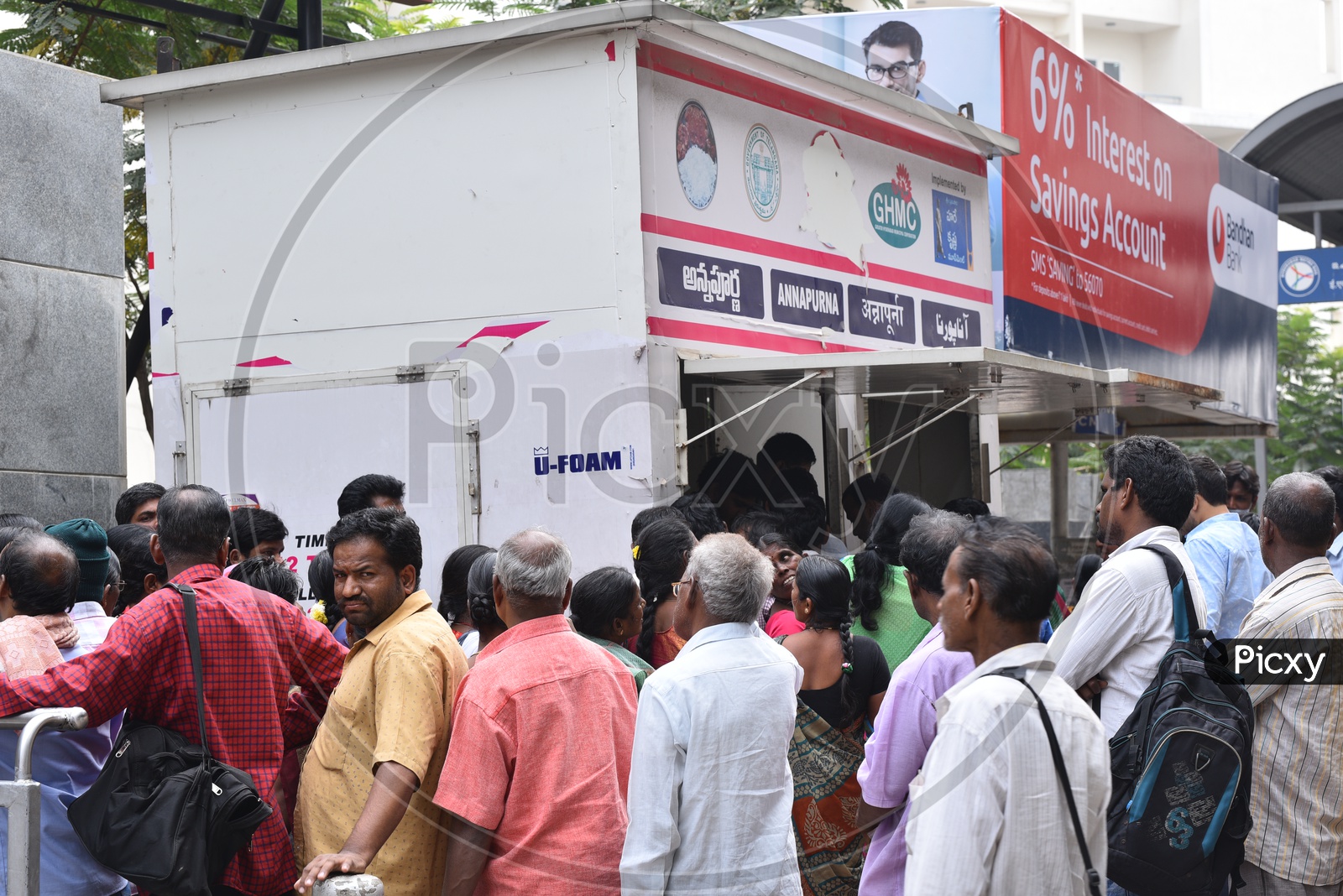 People Standing For Meals At GHMC Annapurna Meal Counter.