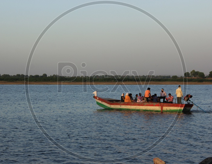 People traveling in Boat across the river