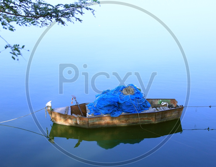 A fisherman boat sailing on a lake.