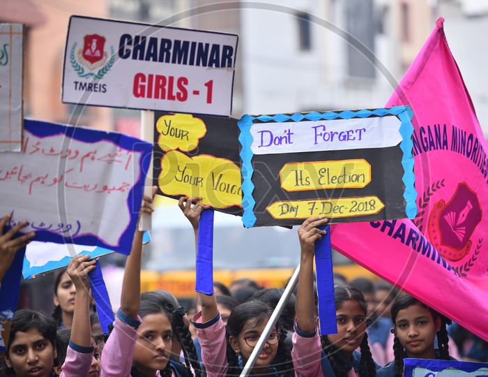 girl students holding a placard for vote awareness