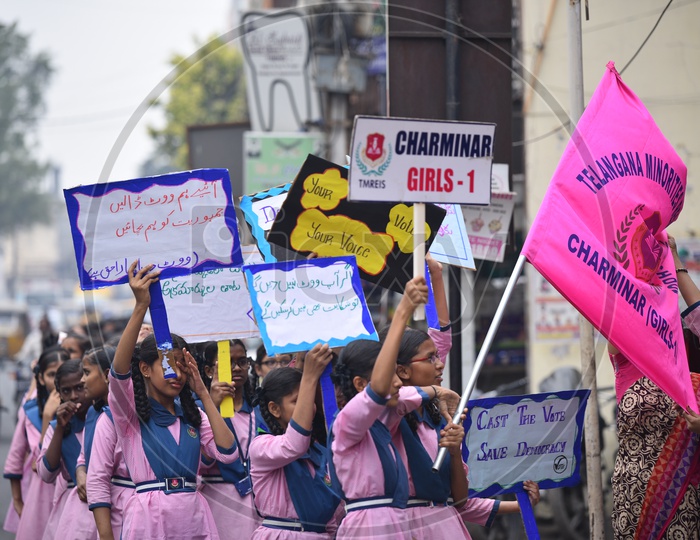 Girl students  showing placards to make use of vote