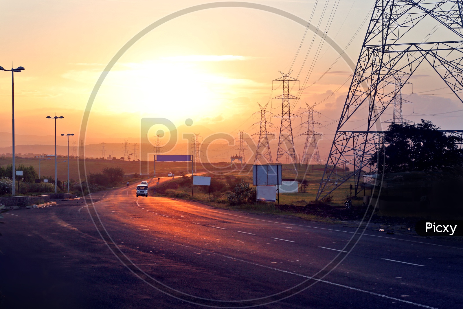 Landscape of Beautiful sunset along the road and electricity towers