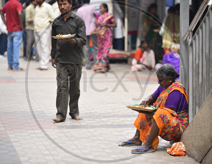 An Old Woman Having her meal brought from GHMC Annapurna Meal Counter.