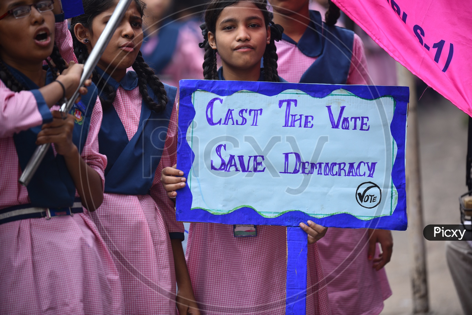 girl student holding a placard for vote awareness