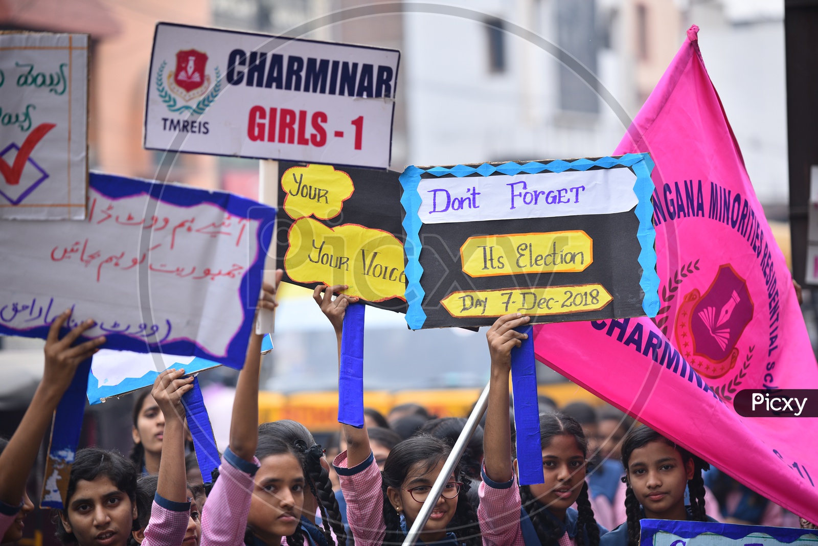 girl students holding a placard for vote awareness