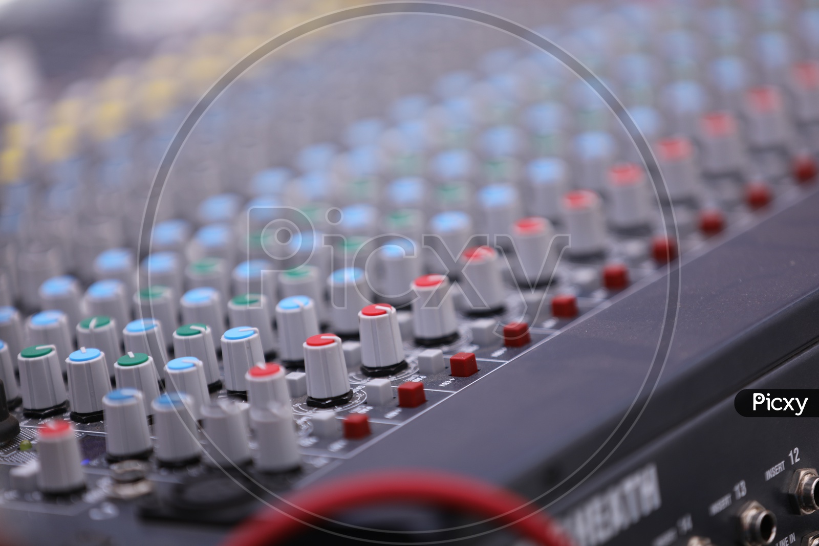 A DJ Mixer Console Closeup Shot presenting The Rows Of Adjusting Tools