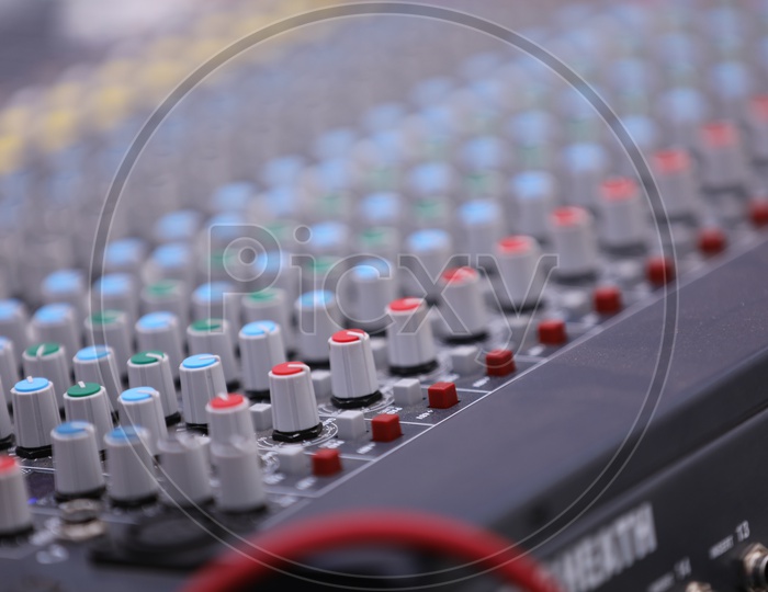 A DJ Mixer Console Closeup Shot presenting The Rows Of Adjusting Tools