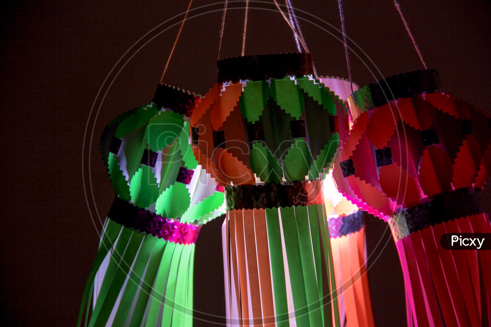 Hanging lanterns made out of paper with dark background