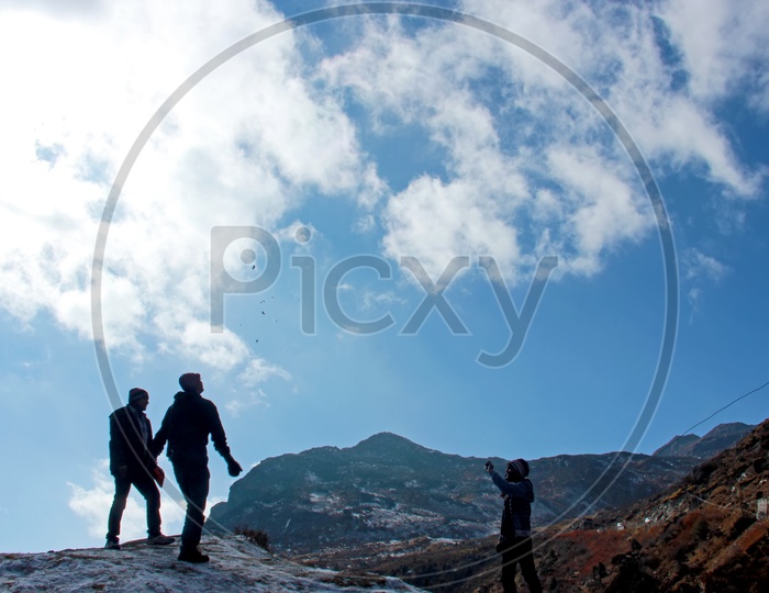 People enjoying trekking on mountains covered with snow