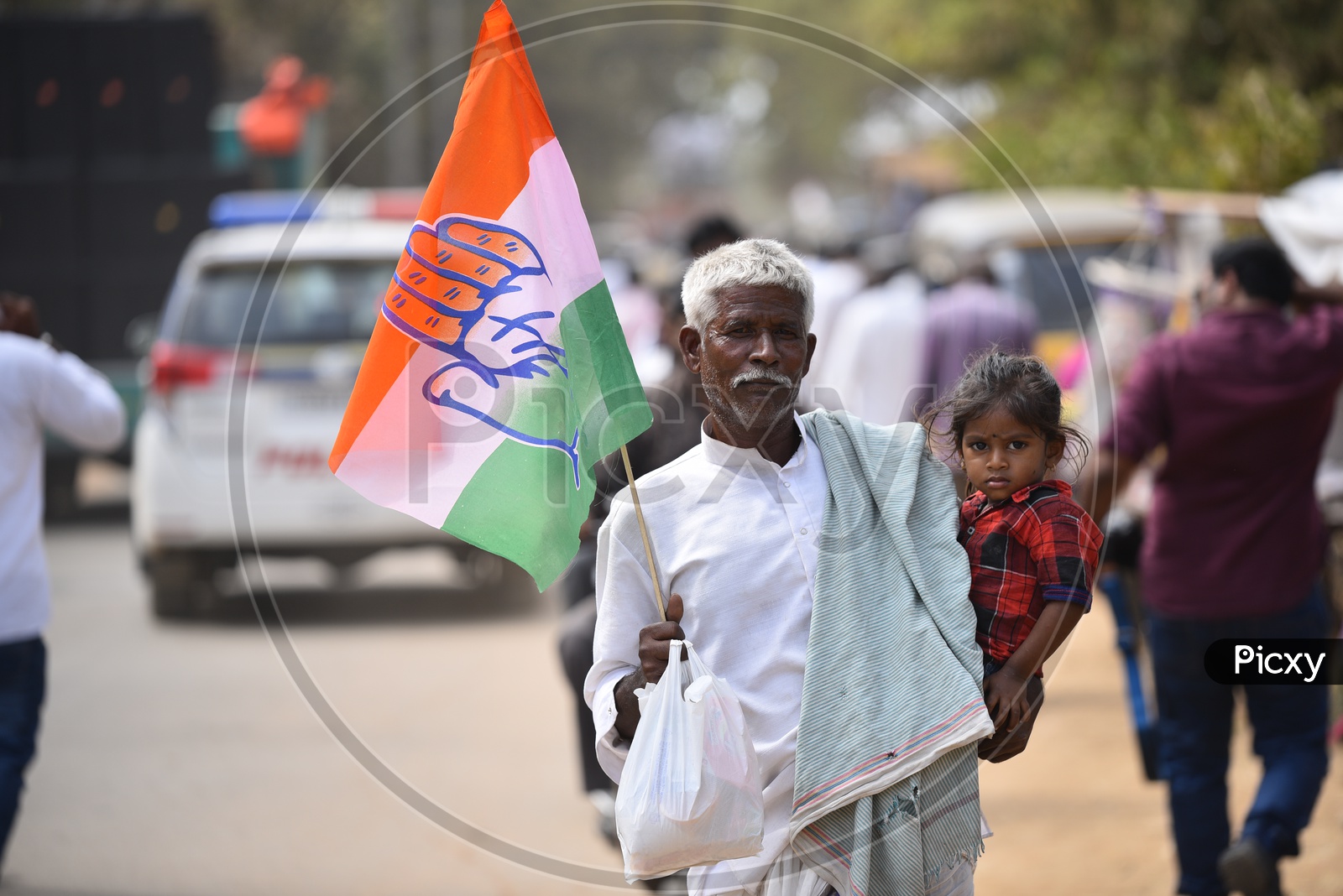 An Old Man Carrying His Grand Child Spotted in Election Rally With a Congress Flag in His Hand  in Tandur