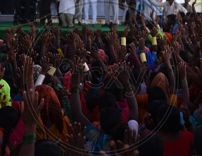 Lady Supporters Raising Thier Hands and Showing Support in a Road Show By Revanth Reddy