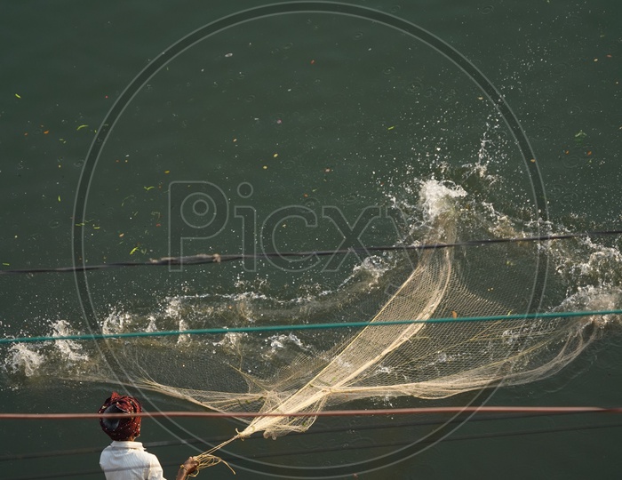 Fishing Net throwing by Fisherman