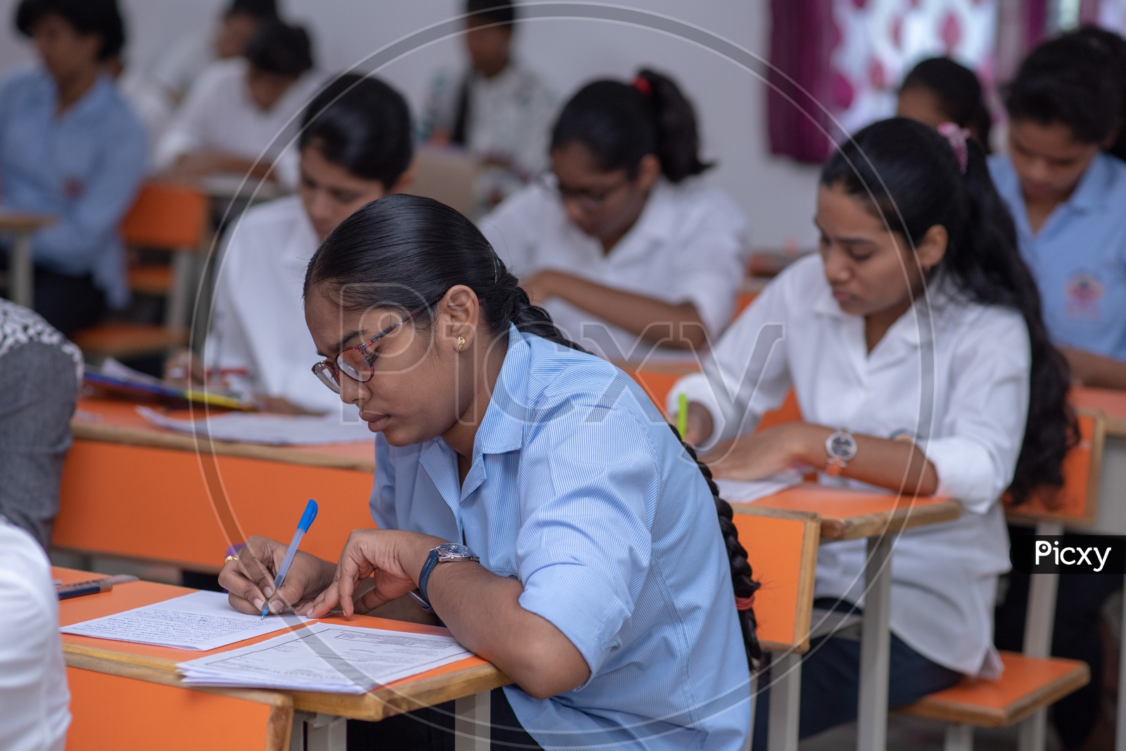 Students writing exams at an educational institute in India