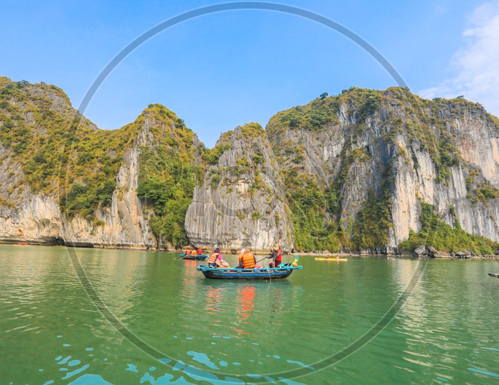 Tourist passengers on Bamboo Boats at Halong Bay, Vietnam.