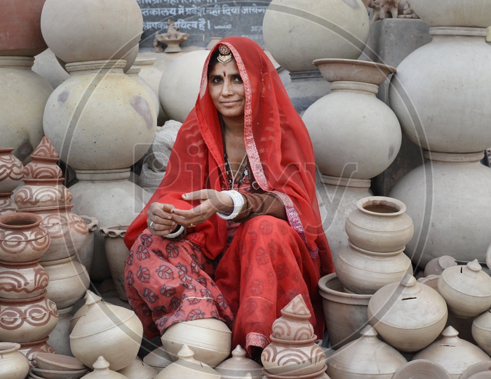 Rajasthani Woman in Traditional Attire Selling Clay Pots