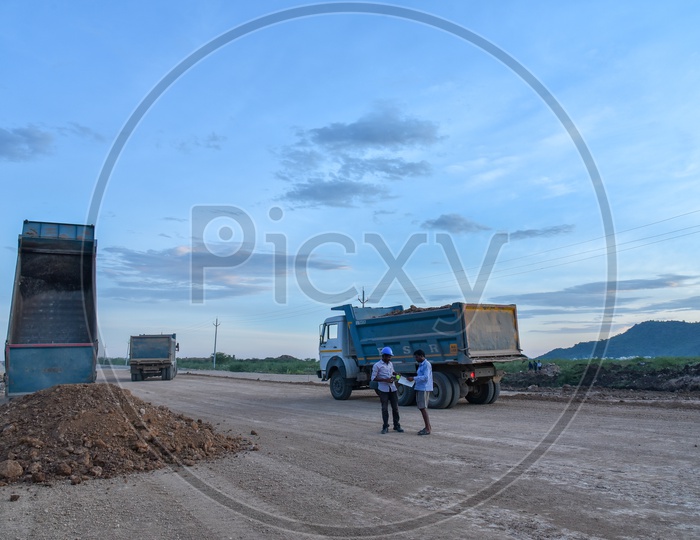 Construction vehicles dispatching Mud on a Road, near Neerukonda. SRM University