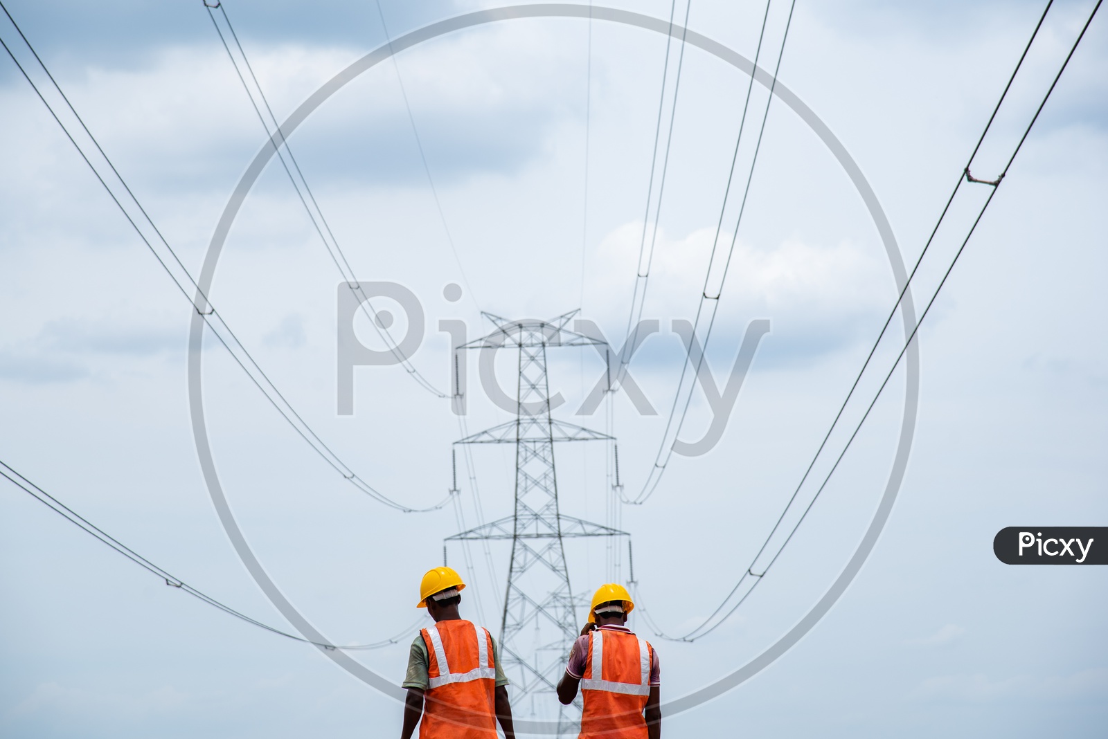 Construction Workers under High Voltage Electricity Wires.