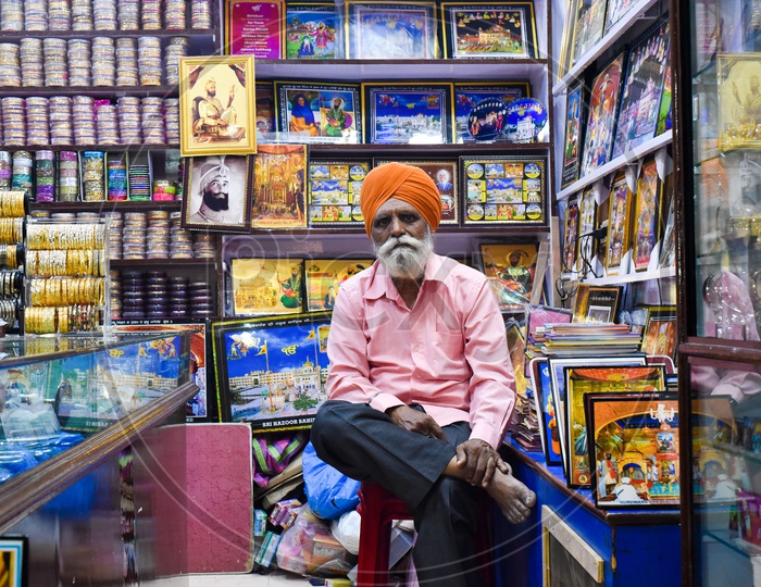 Sardar at Store selling Idols and Diety Frames