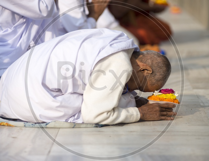 Devotee praying at Mahabodhi Temple, Bodh Gaya