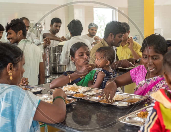 mother feeding her child in anna canteen
