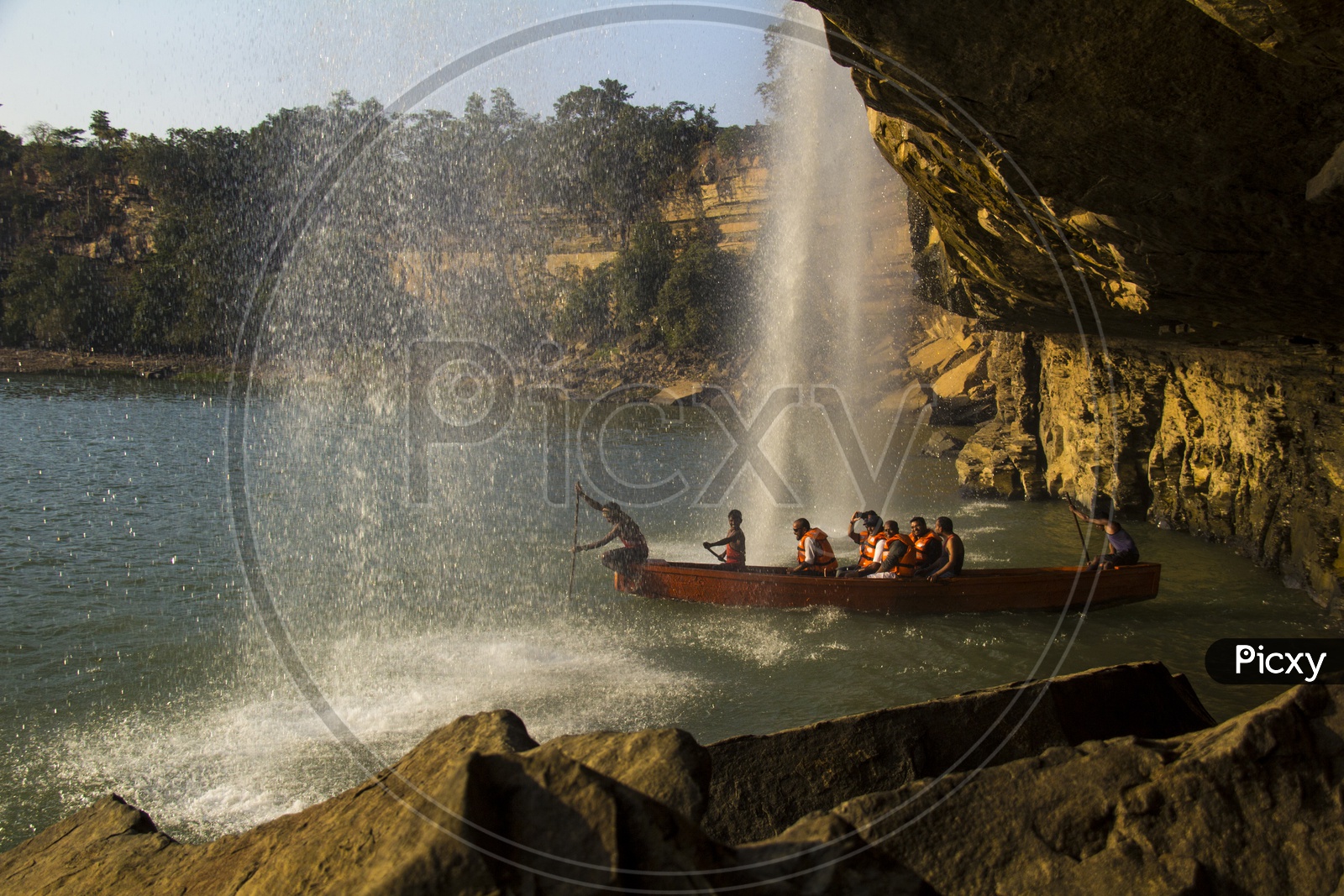 Tourists enjoying boat trip to water Falls