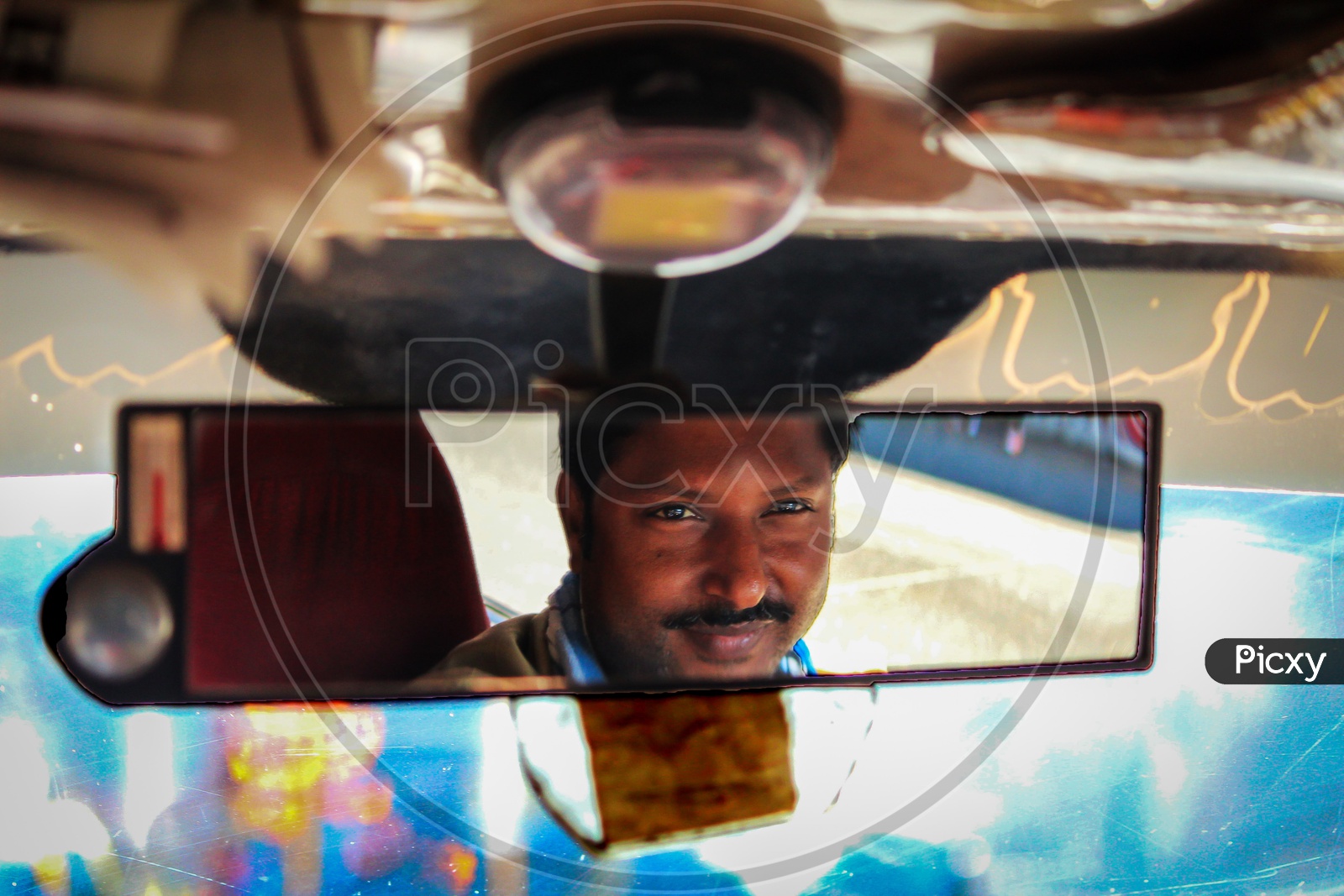 taxiwala looking in the mirror of taxi