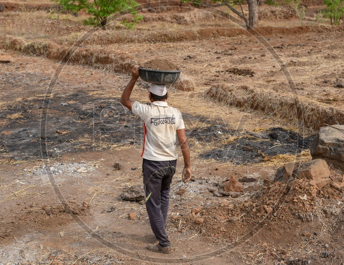 Farmer carrying soil to the fields
