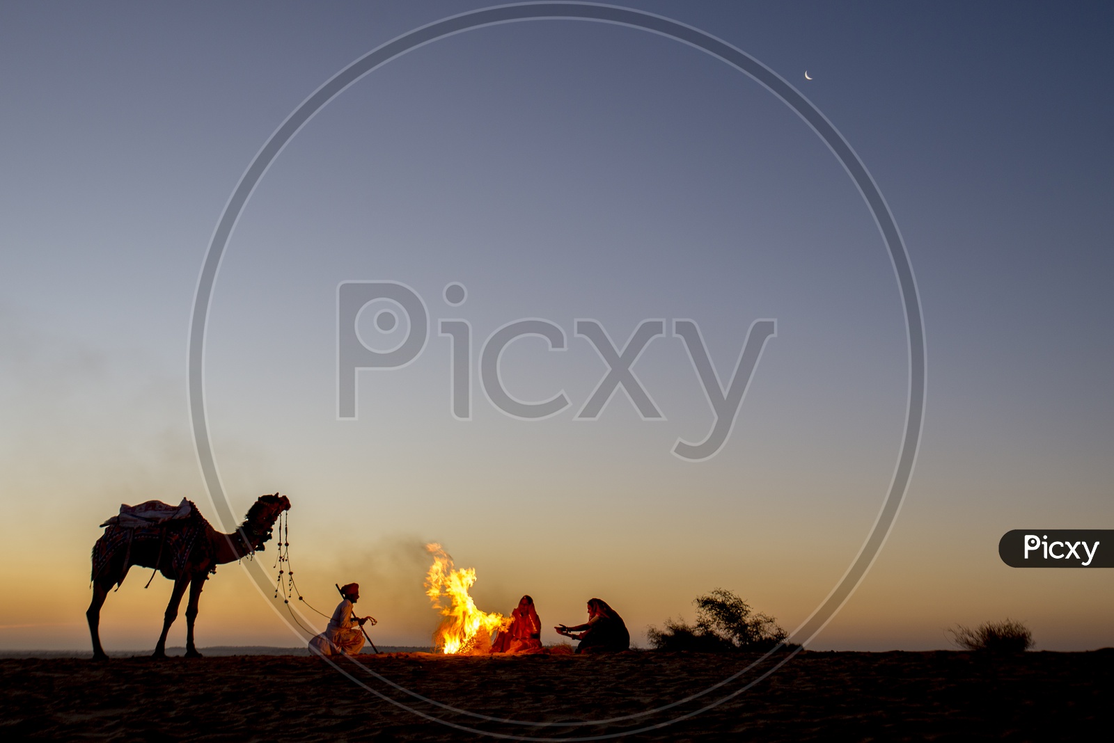 People sit around bonfire in Desert, Rajasthan