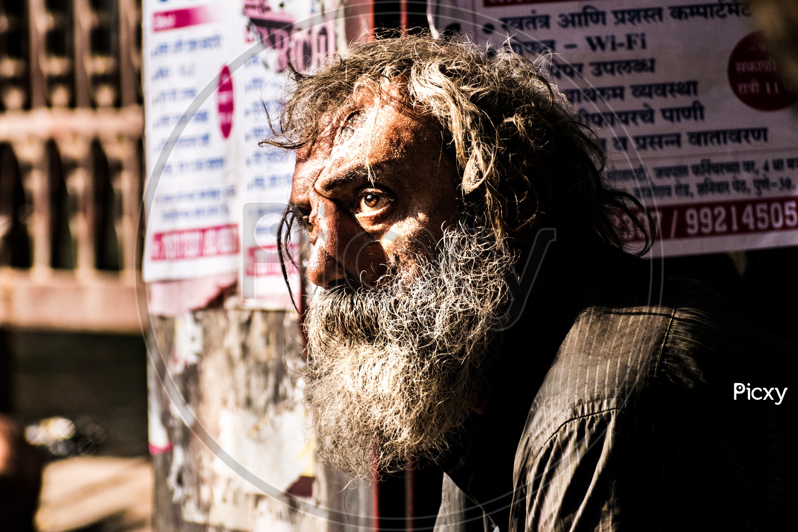 Very old man begging on streets and looking in hope