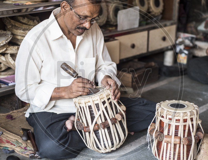 Tuning the tabla (Indian version of Drum)