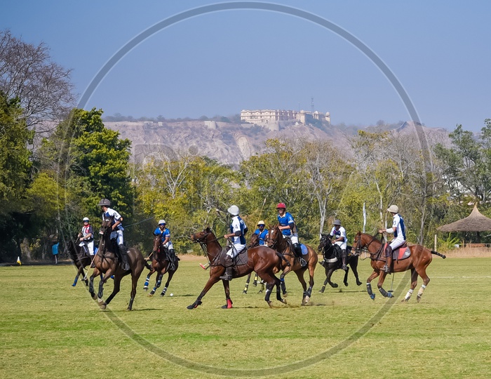 Polo Match at Rajasthan Polo Club with Nahargarh Fort in background.