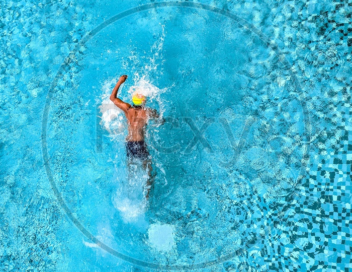 Man Swimming in a Pool