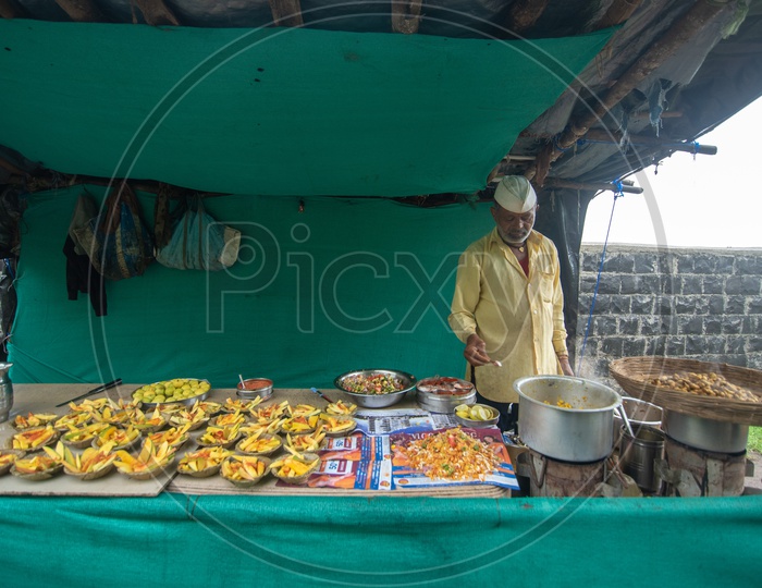 Vendor selling mangoes, peanuts and other food items at Sinhagad Fort