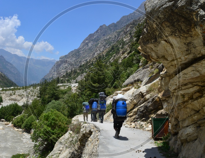 People Carrying Luggage to the top of mountains