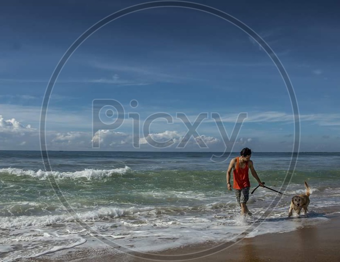 Man with dog near Beach