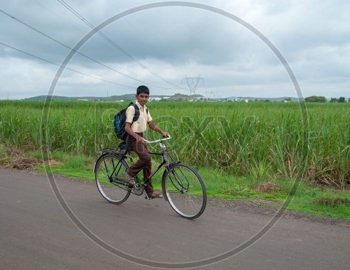 School Kid in uniform rides bicycle to school.