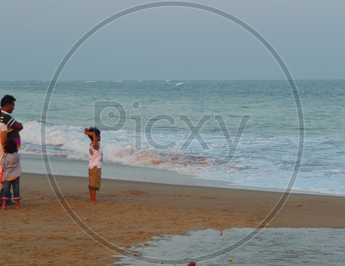 Family enjoying Waves on Shore, Bay of Bengal Sea