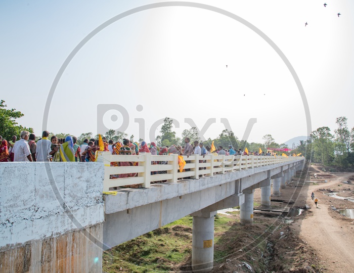 People walking for the First Time on the Bridge built recently on Bahudha River, Boddabada.