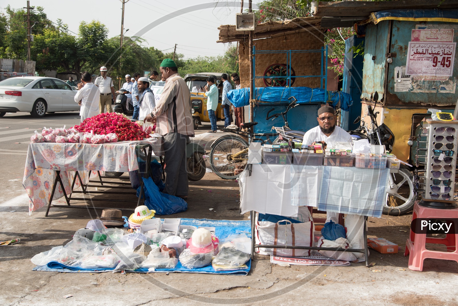 Vendors selling flower, caps and attar during Eid
