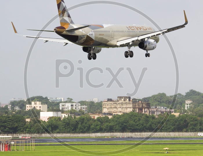 Etihad airways A321 flaring over runway for its touchdown.