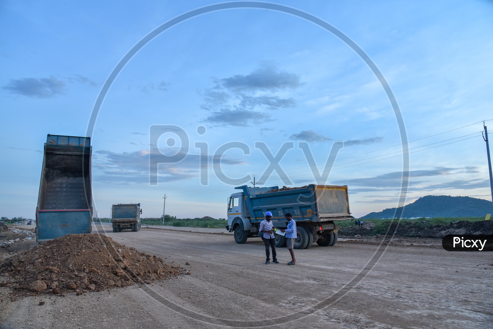 Construction vehicles dispatching Mud on a Road, near Neerukonda. SRM University