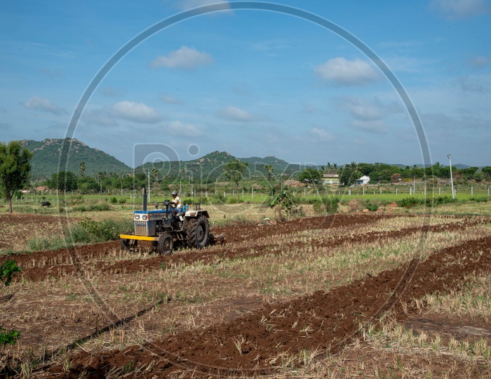 Farmer working on fields on tractor