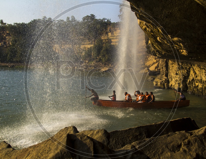 Tourists enjoying boat trip to water Falls