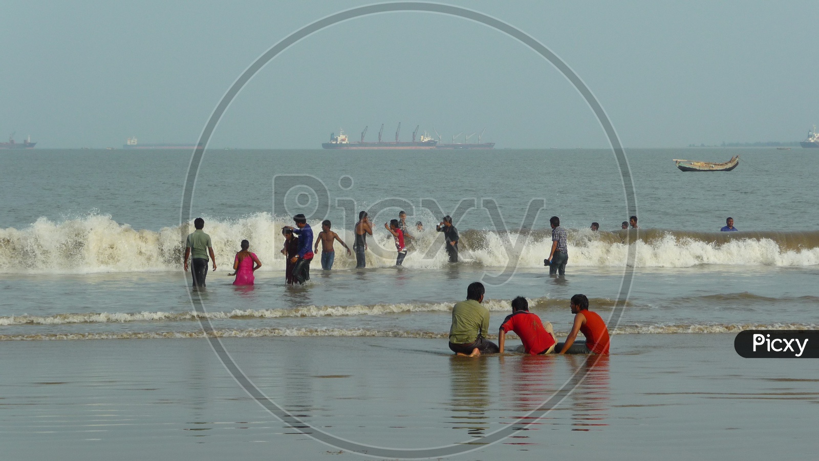 People enjoying waves at Kakinada Beach